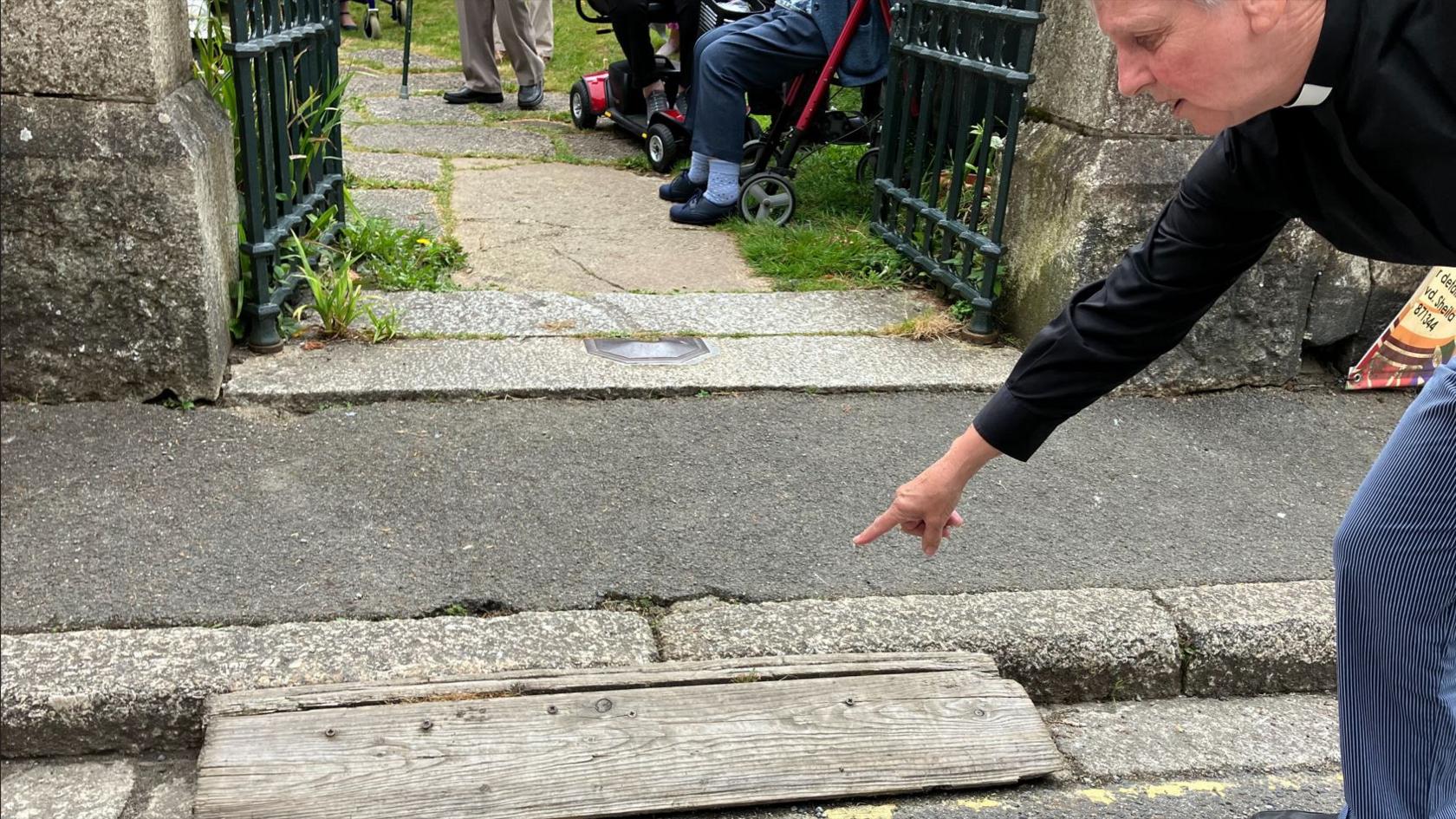 A woman pointing at a disabled access ramp