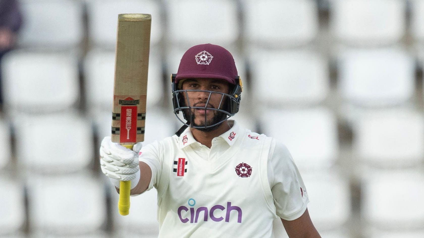 Emilio Gay raises his bat during his career-best 261 against Middlesex