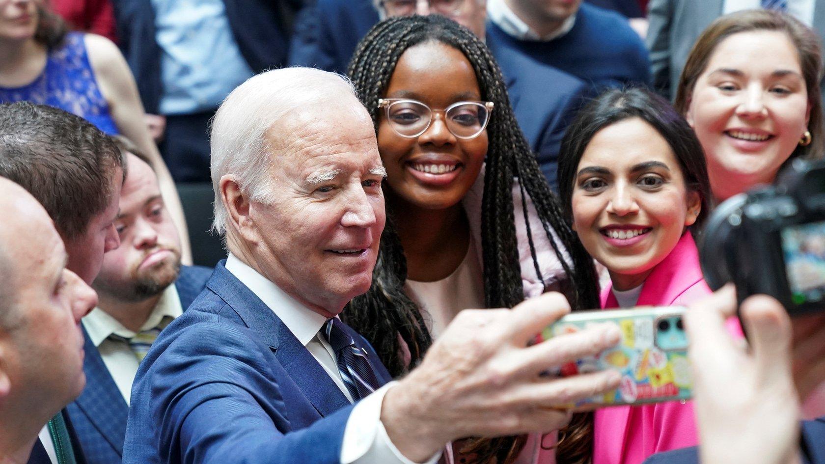 Joe Biden takes a selfie with students on the 25th anniversary of the Belfast/Good Friday Agreement, at Ulster University, Belfast, Northern Ireland April 12, 2023. REUTERS/Kevin Lamarque