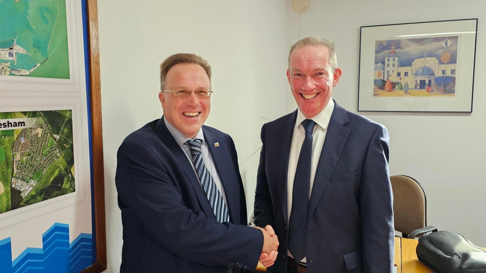 Former Labour councillor Charles Woodgate shakes hands with leader of the Conservatives in Dover after he defected from Labour 