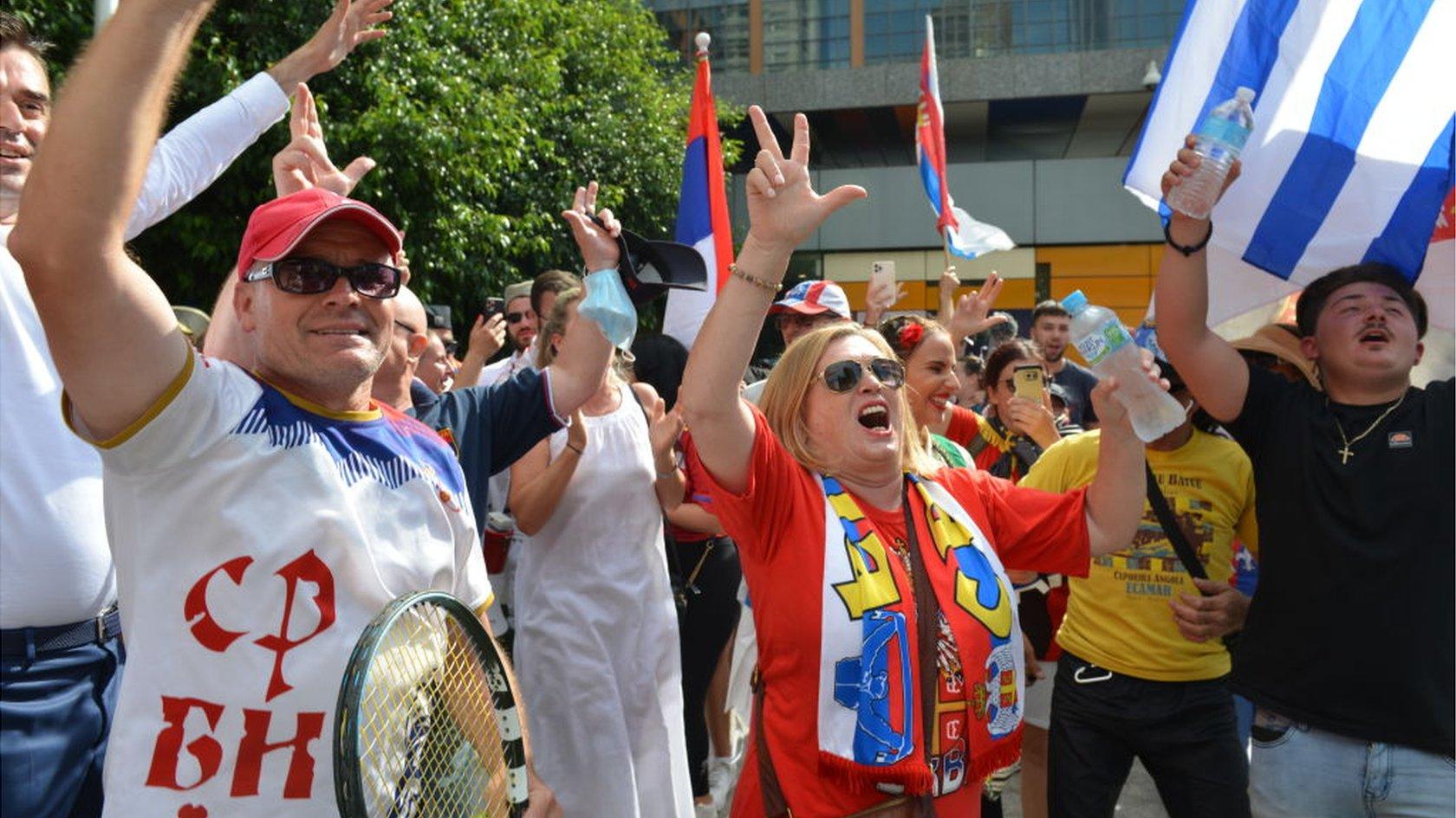 People celebrate after Australian court quashes visa cancellation for Novak Djokovic on 10 January 2022 in Melbourne, Australia