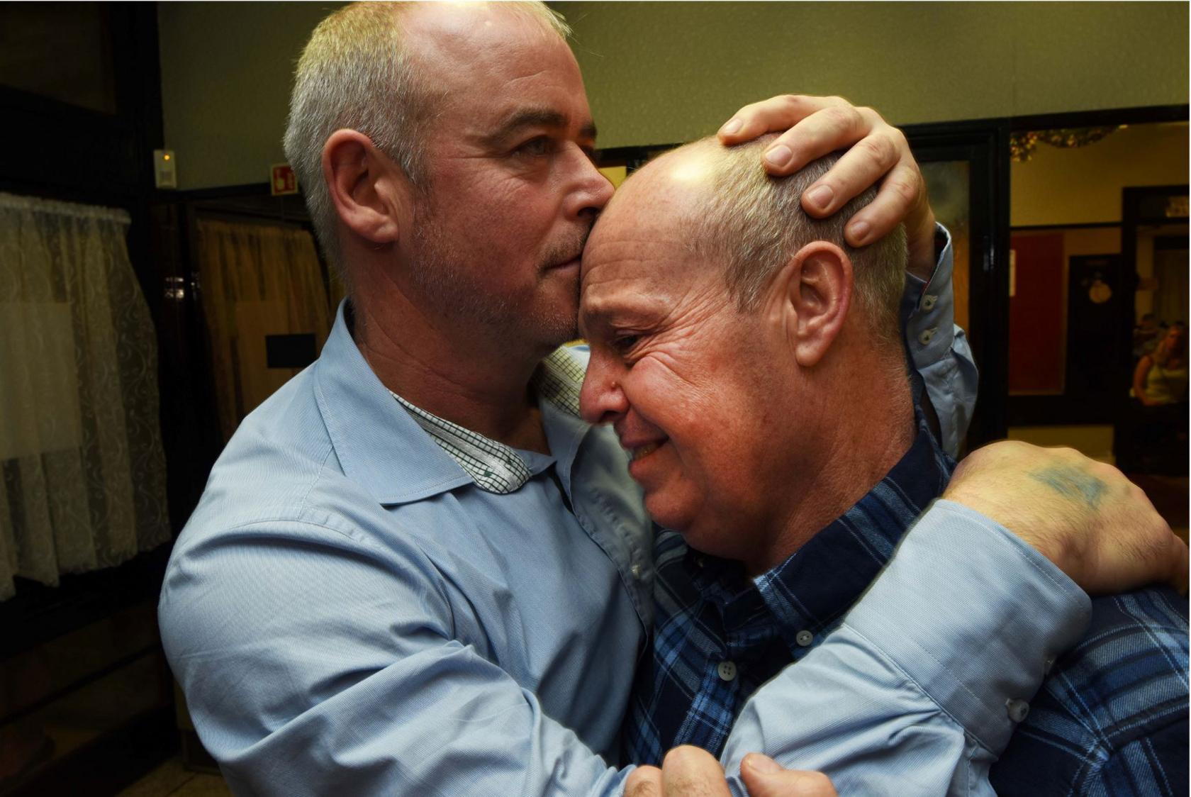 Miners comfort each other at a party held following the 2015 closure of Kellingley Colliery, North Yorkshire, the last deep coal mine in the UK