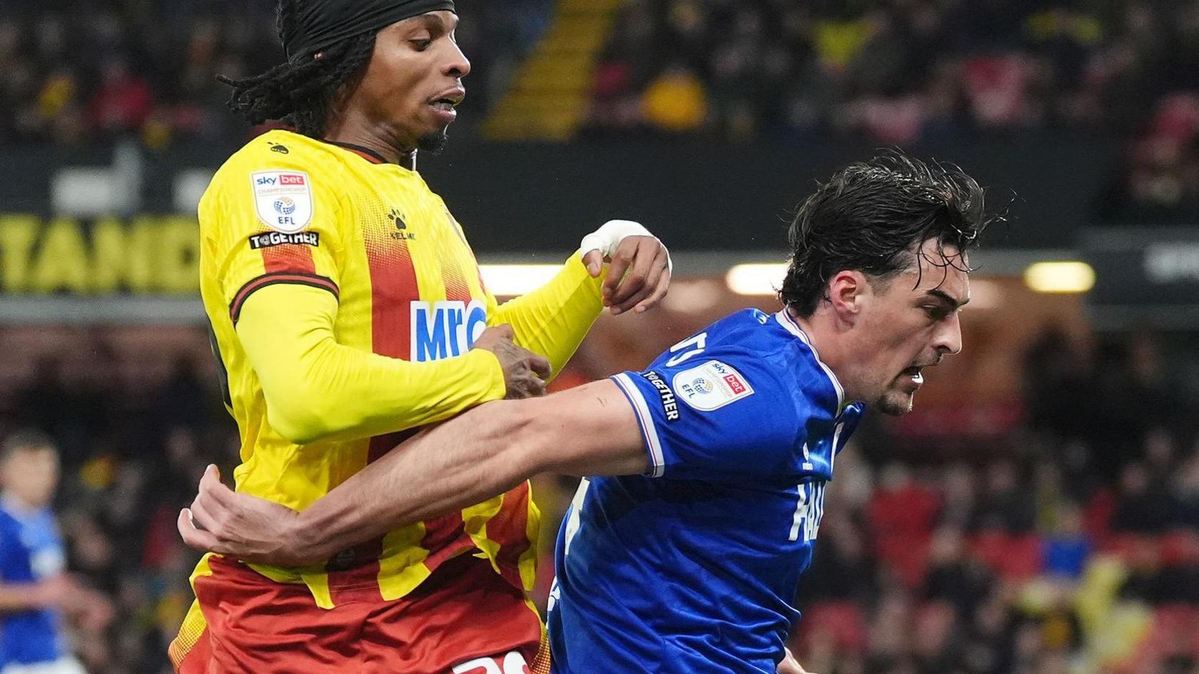 Jacob Greaves (right) uses his arms and body to prevent Watford's Jeremy Petris from getting to the ball