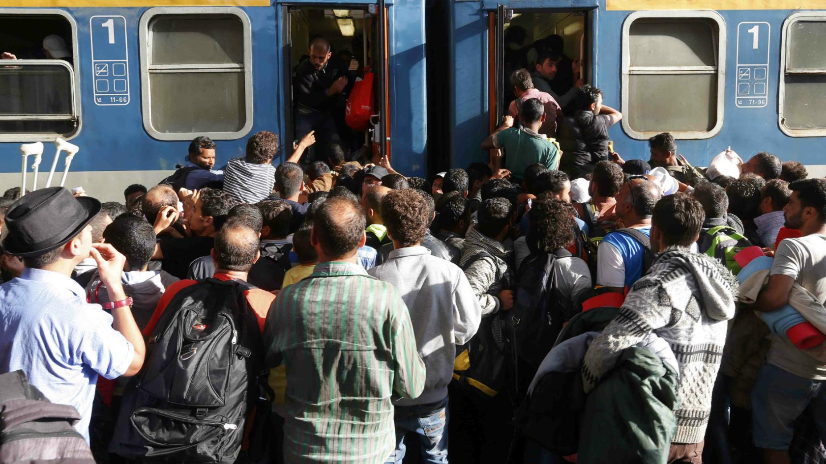 Migrants storm into a train at the Keleti train station in Budapest, Hungary - 3 September 2015