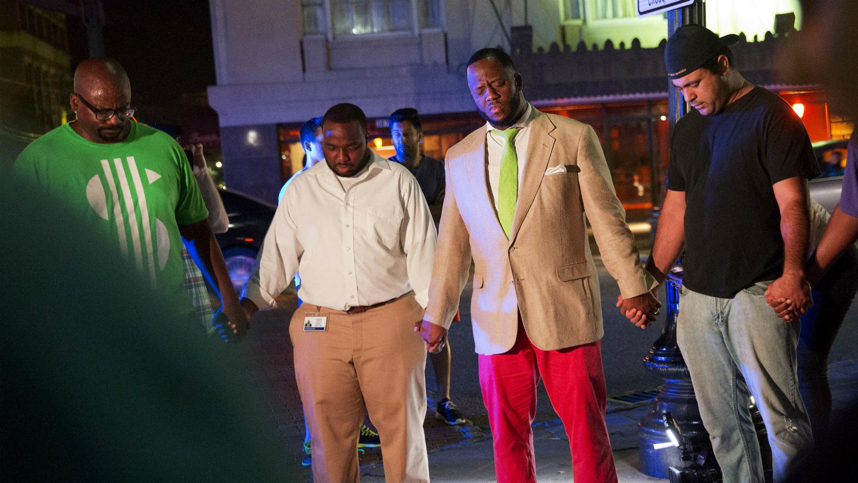 Worshippers gather to pray down the street from the Emanuel AME Church following a shooting Wednesday in Charleston - 17 June 2015