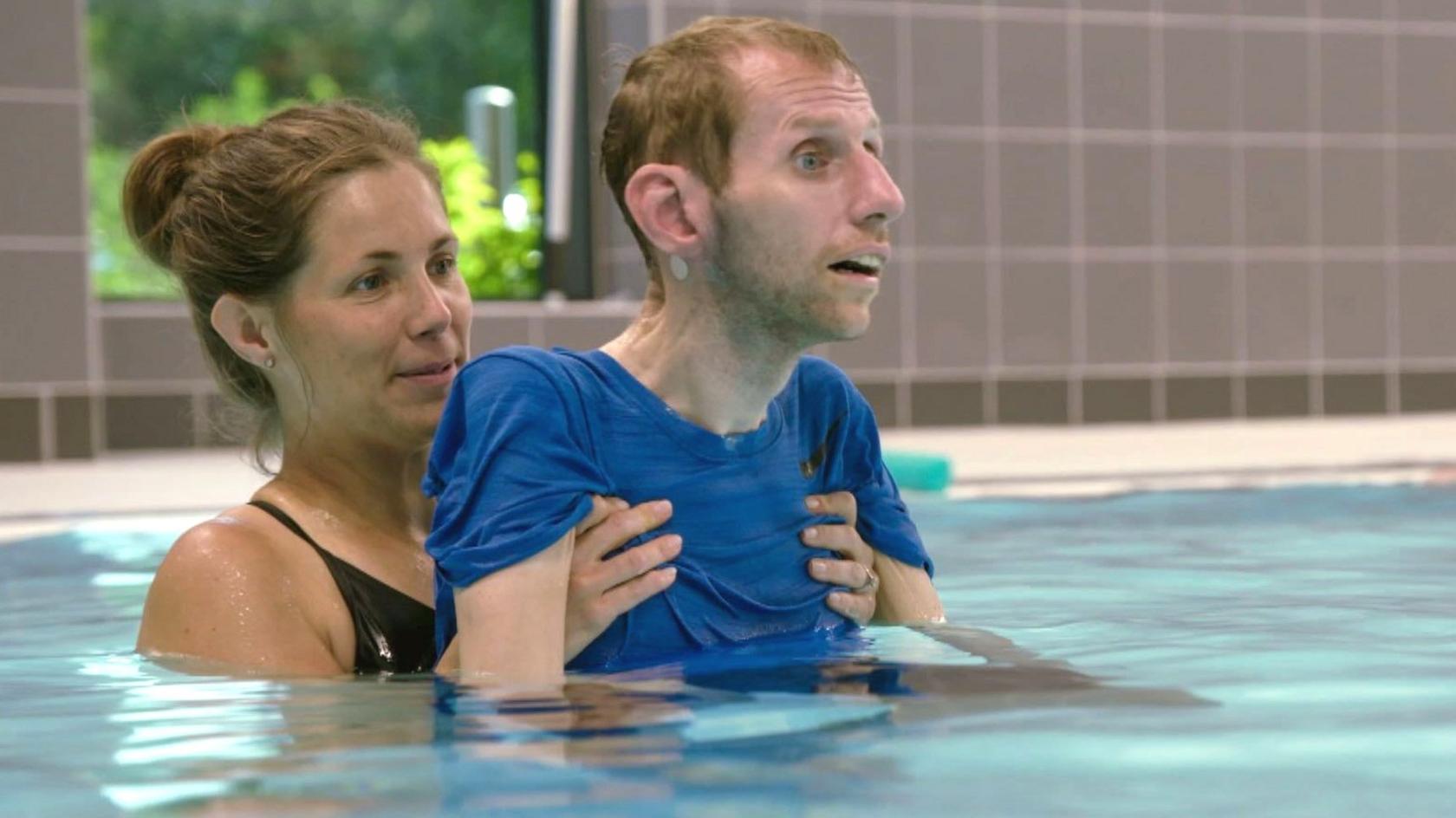 Rob's wife, Lindsey, helps him with physiotherapy in the swimming pool.