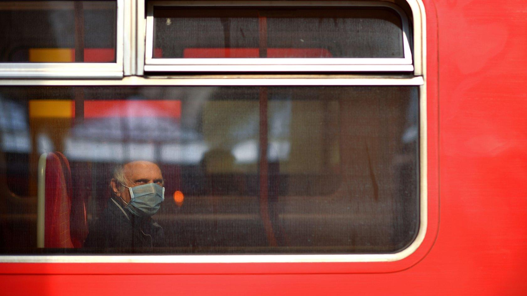 Man wearing face mask on a bus