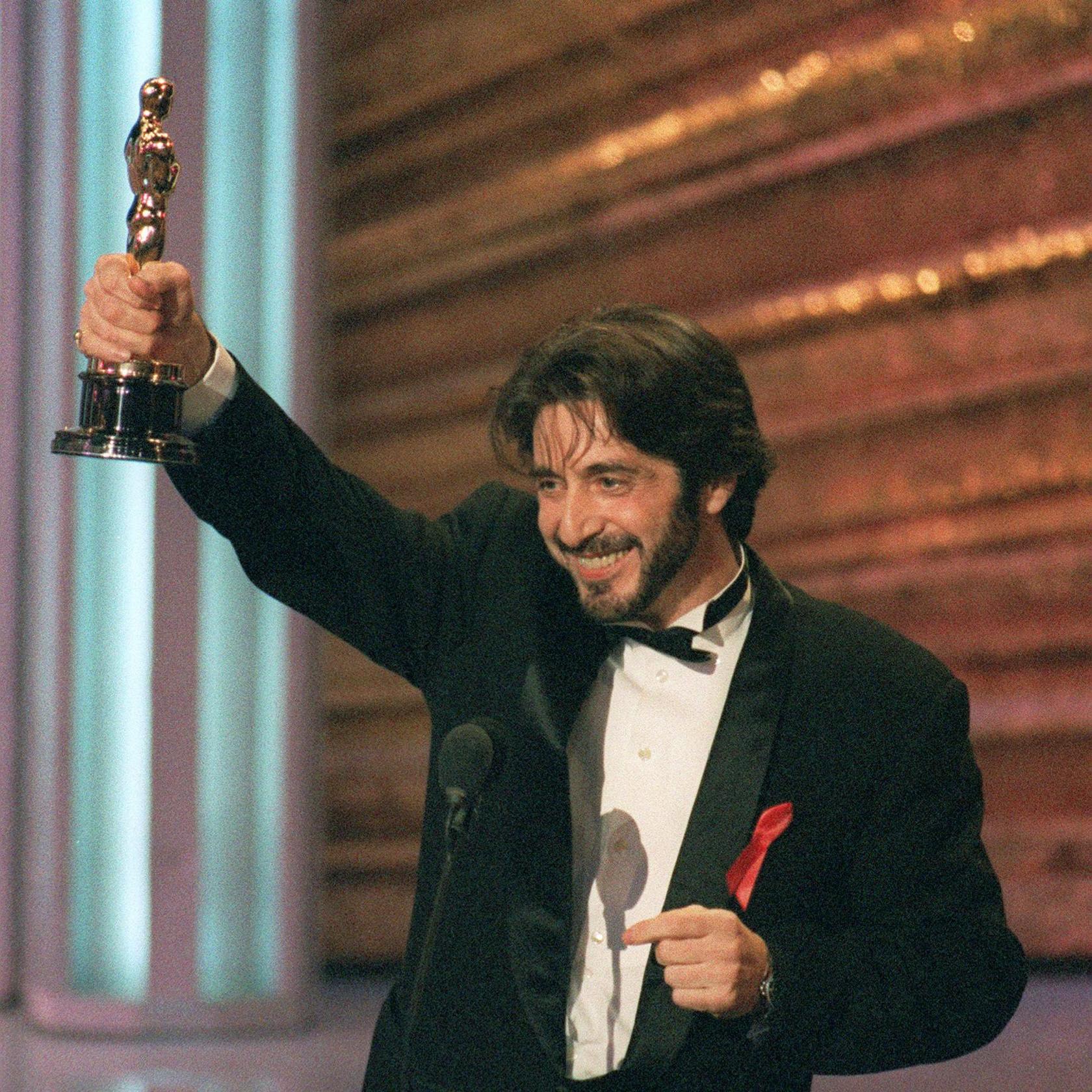 Pacino at the 1993 Academy Awards where he won his first and only Oscar for his performance in Scent of a Woman - he is smiling and holding the statuette aloft in one hand