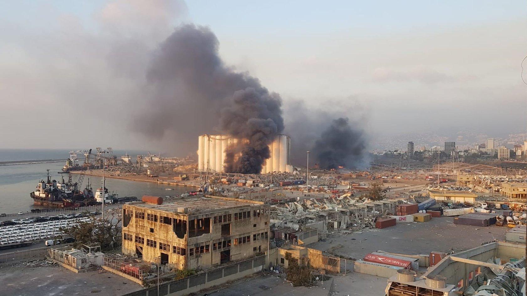 An image made with a mobile phone showing a general view of the harbor area with smoke billowing from an area of a large exoplosion