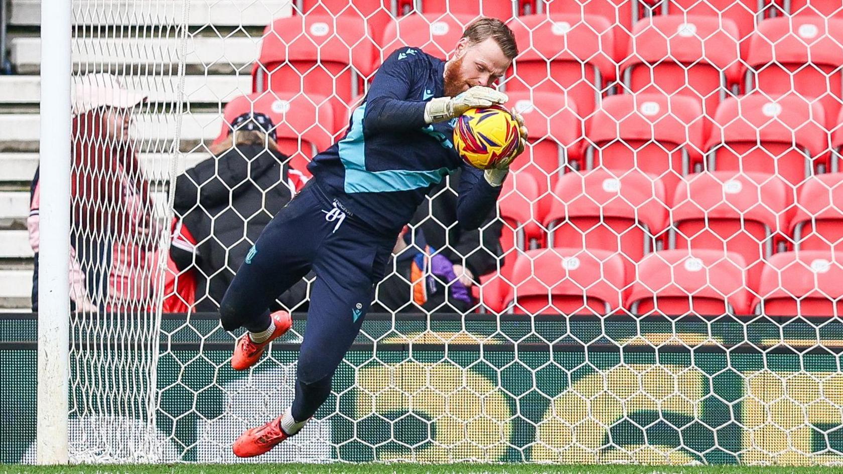 Stoke City keeper Viktor Johansson warming up before their game against Plymouth Argyle in January