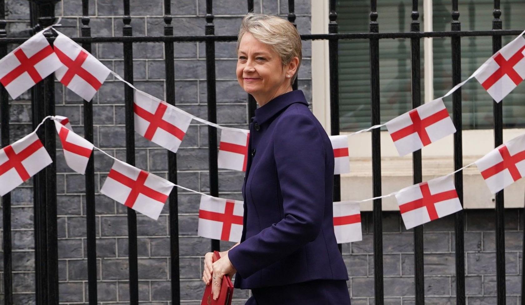 Home Secretary Yvette Cooper arrives at Downing Street in front of a row of English flags