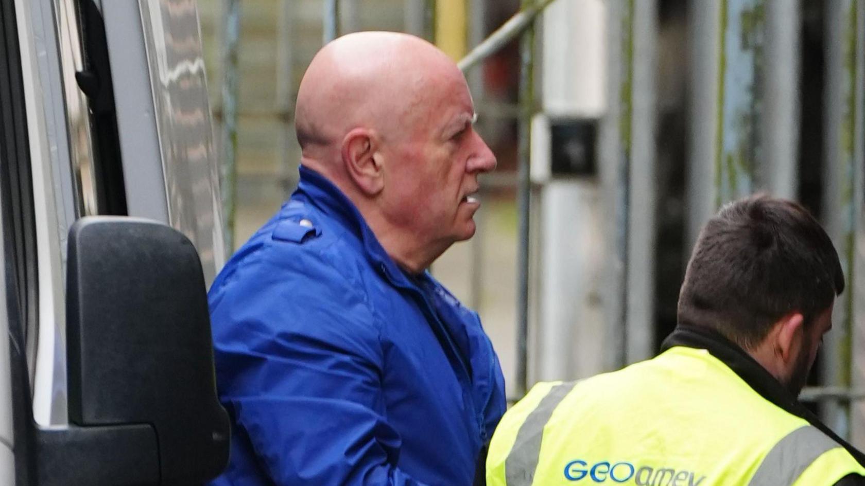 Neil Foden yn cael ei dywys i'r llys