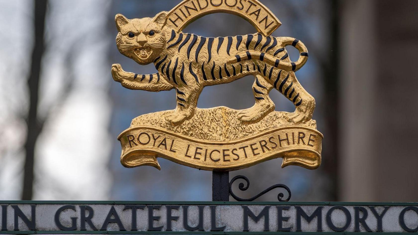 A detail of ornamental gilded iron work in the shape of a stylised tiger, commemoration the Royal Leicestershire Regiment's service in 'Hindoostan'