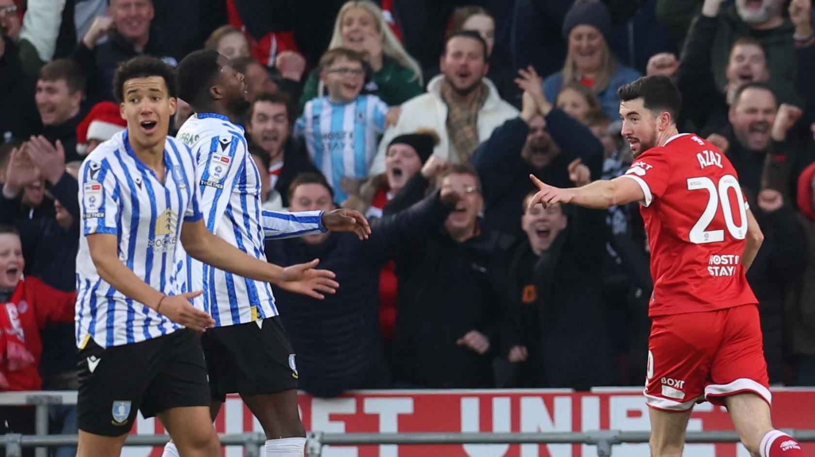 Finn Azaz celebrates one of his goal as two Sheff Wed defenders look on 