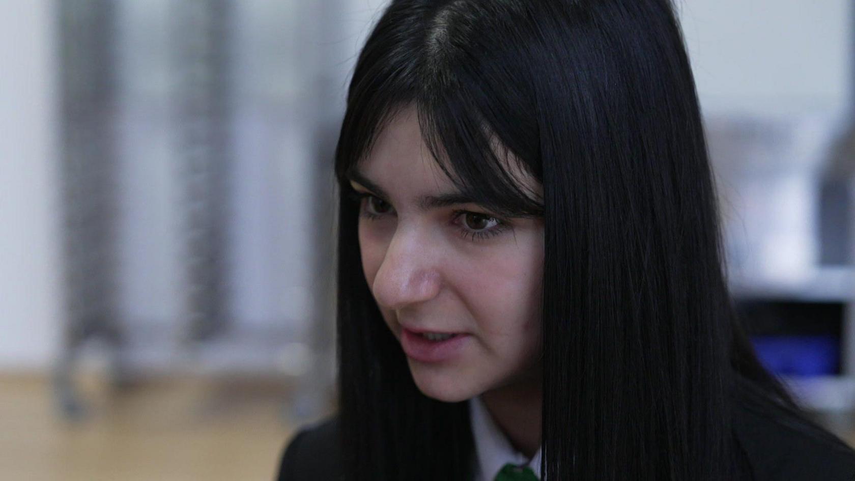 Sandra, a 14-year-old schoolgirl with long black hair 