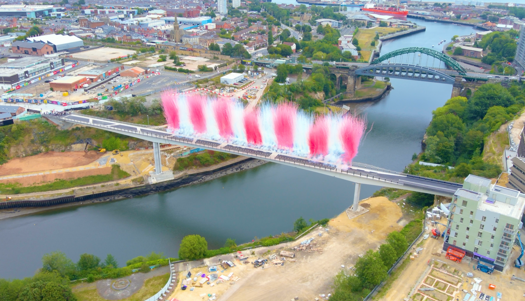 Keel Crossing footbridge when it opened for one day in August for the Women's Rugby World Cup, taken overhead by a drone. Red and white flares - to represents the local football club - can be seen shooting high into the sky.