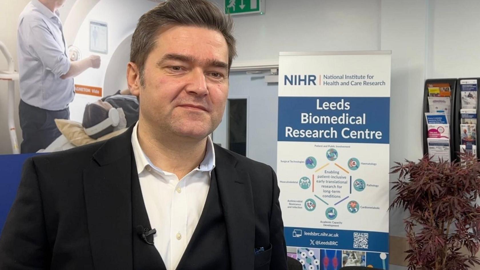 Prof Sinisa Savic, a man with dark hair wearing a suit in the Leeds Biomedical Research Centre