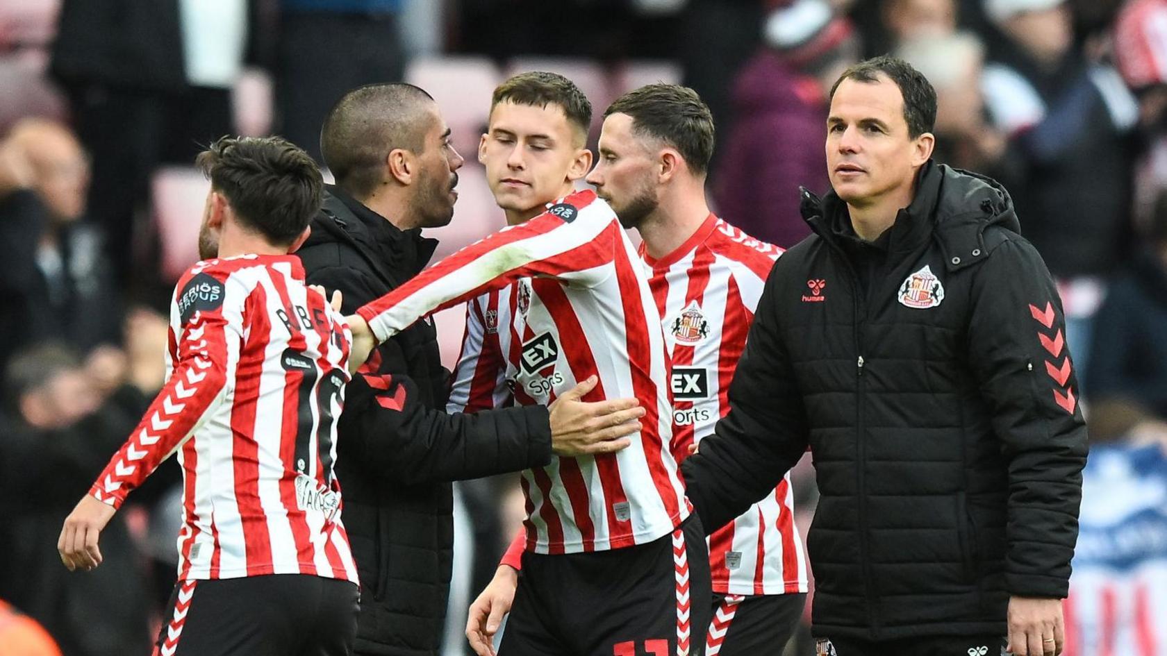 Patrick Roberts (left, with his back turned) chats with Chris Rigg (centre), an assistant coach and Regis Le Bris (right)