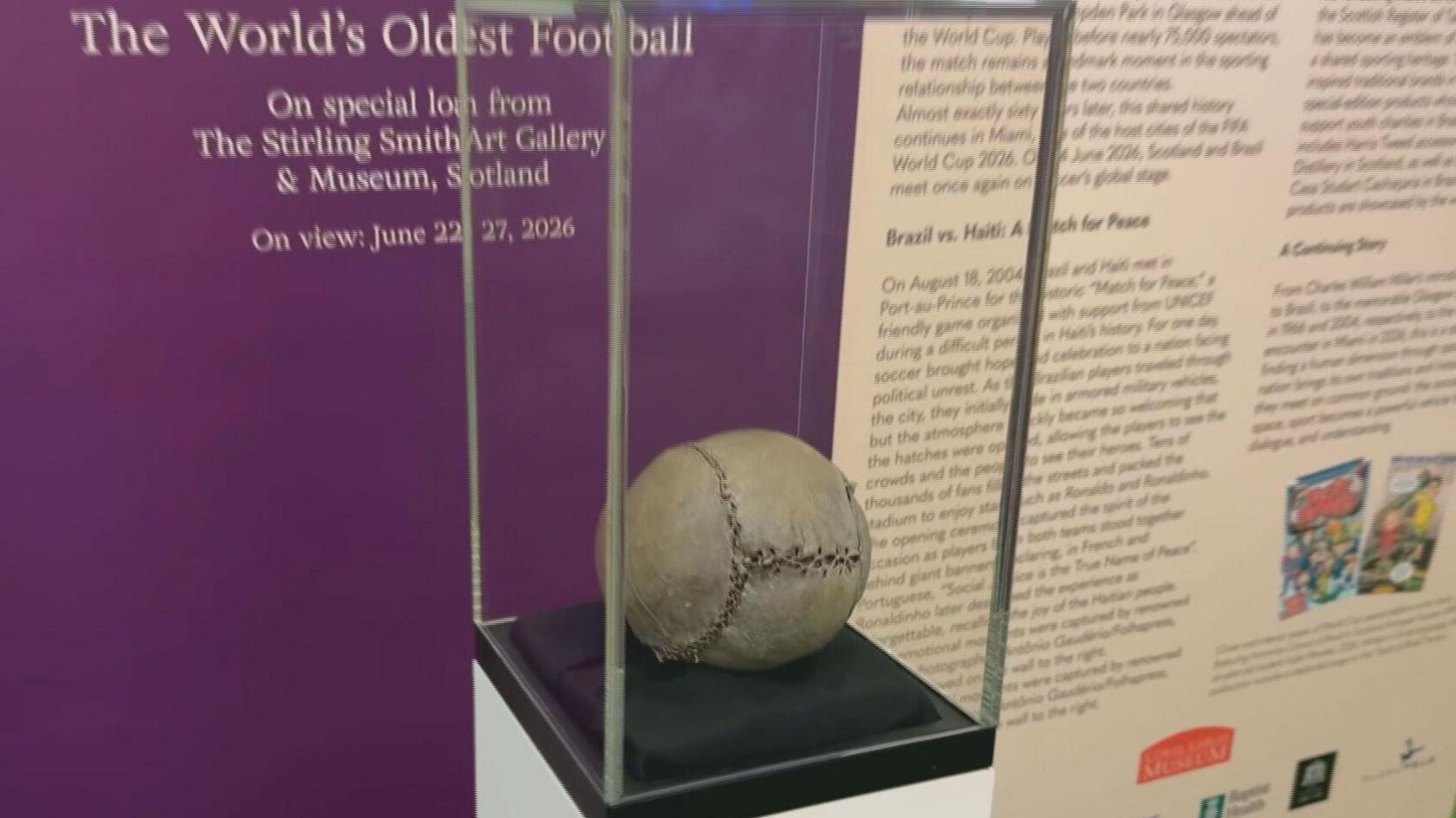 An almost 500-year-old football in a glass case in a museum