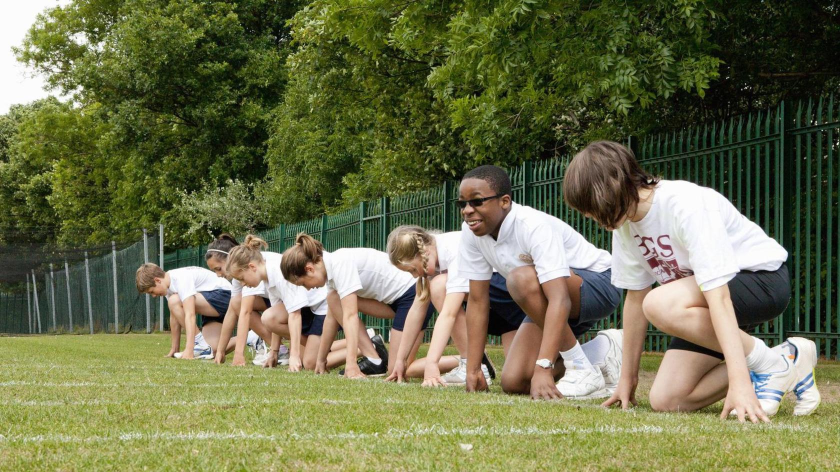 Children getting ready to race on a sports field