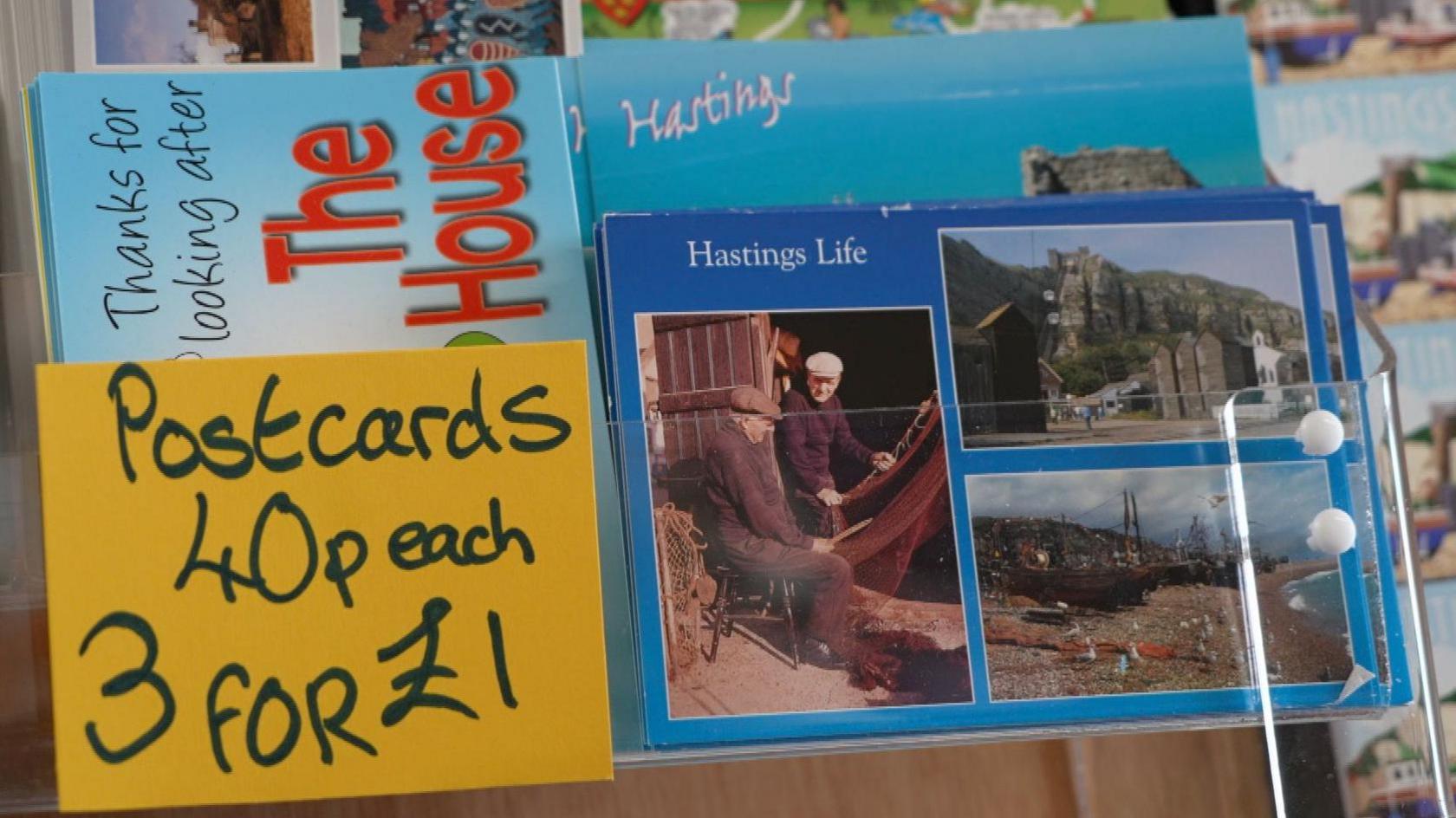 A selection of postcards advertising Hastings, East Sussex. The following offer is advertised: "Postcards - 40p each. Three for £1."