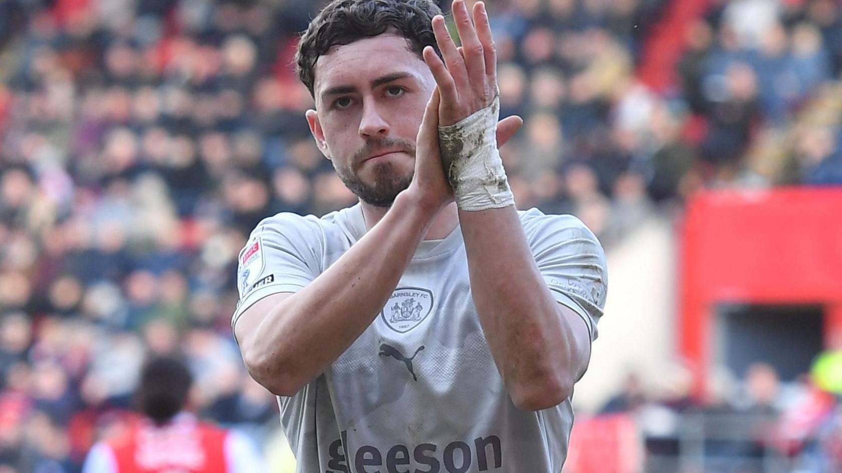Corey O'Keeffe applauds the Barnsley fans