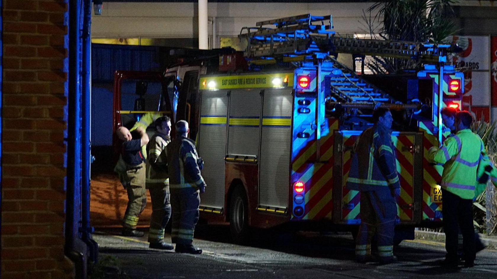 An East Sussex Fire and Rescue Service crew by a fire engine