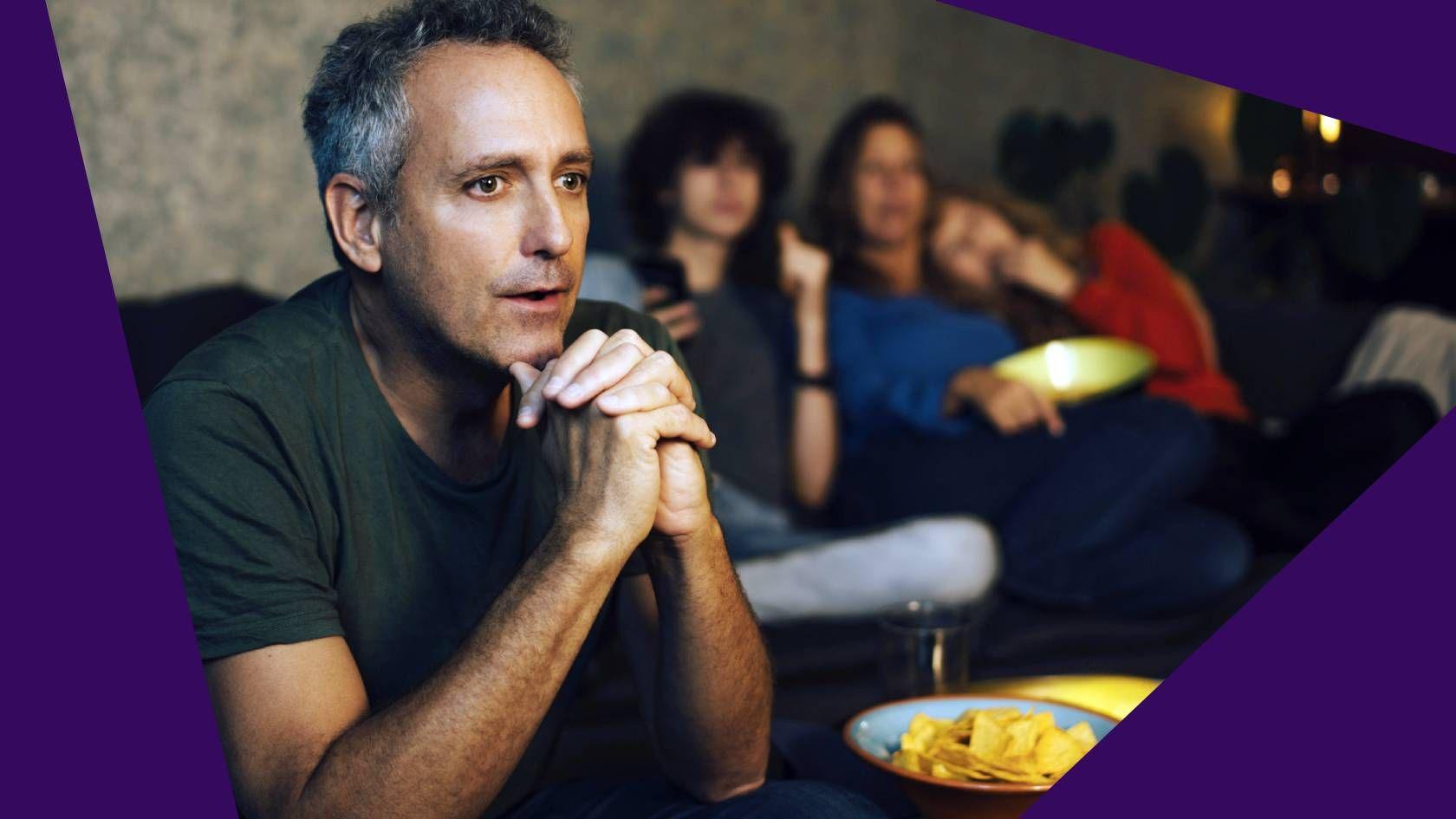 Man with family watching TV