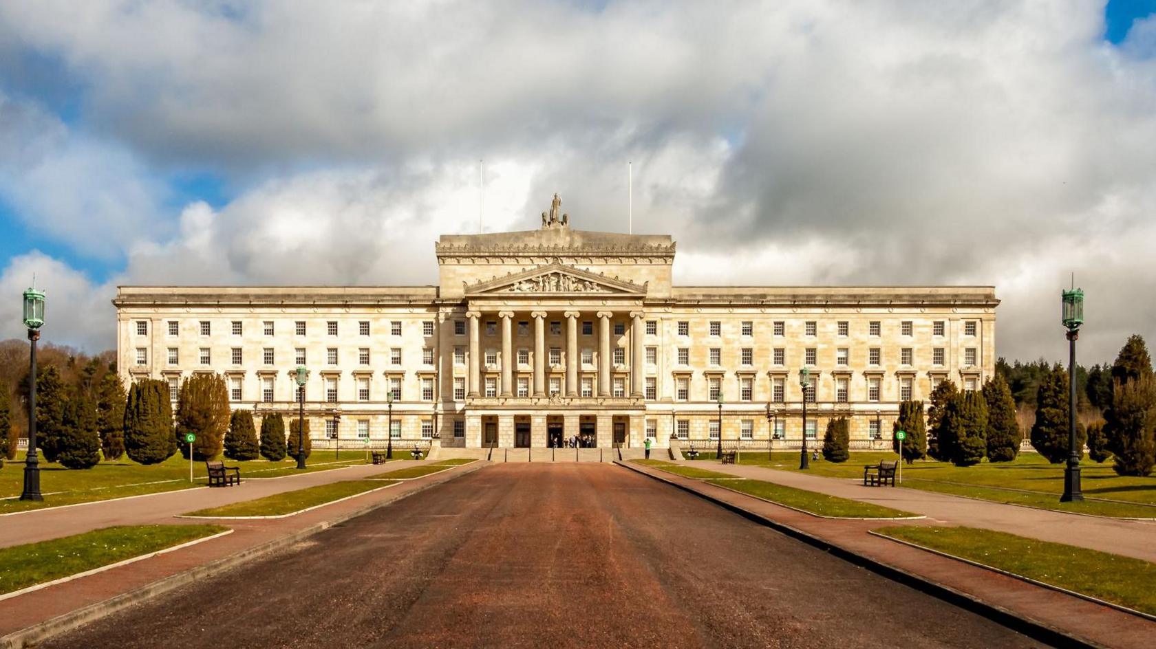 Stormont buildings. The front of the treelined path is shown.