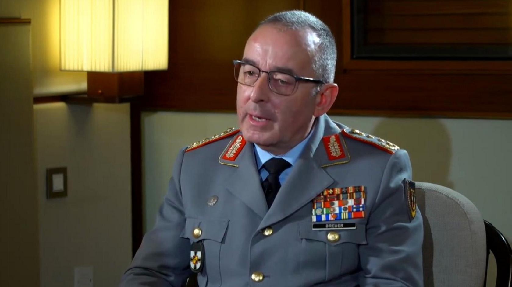 Germany's Chief of Defence Staff, General Carsten Breuer, sits in military uniform during a BBC interview. He has close-cropped hair and glasses.