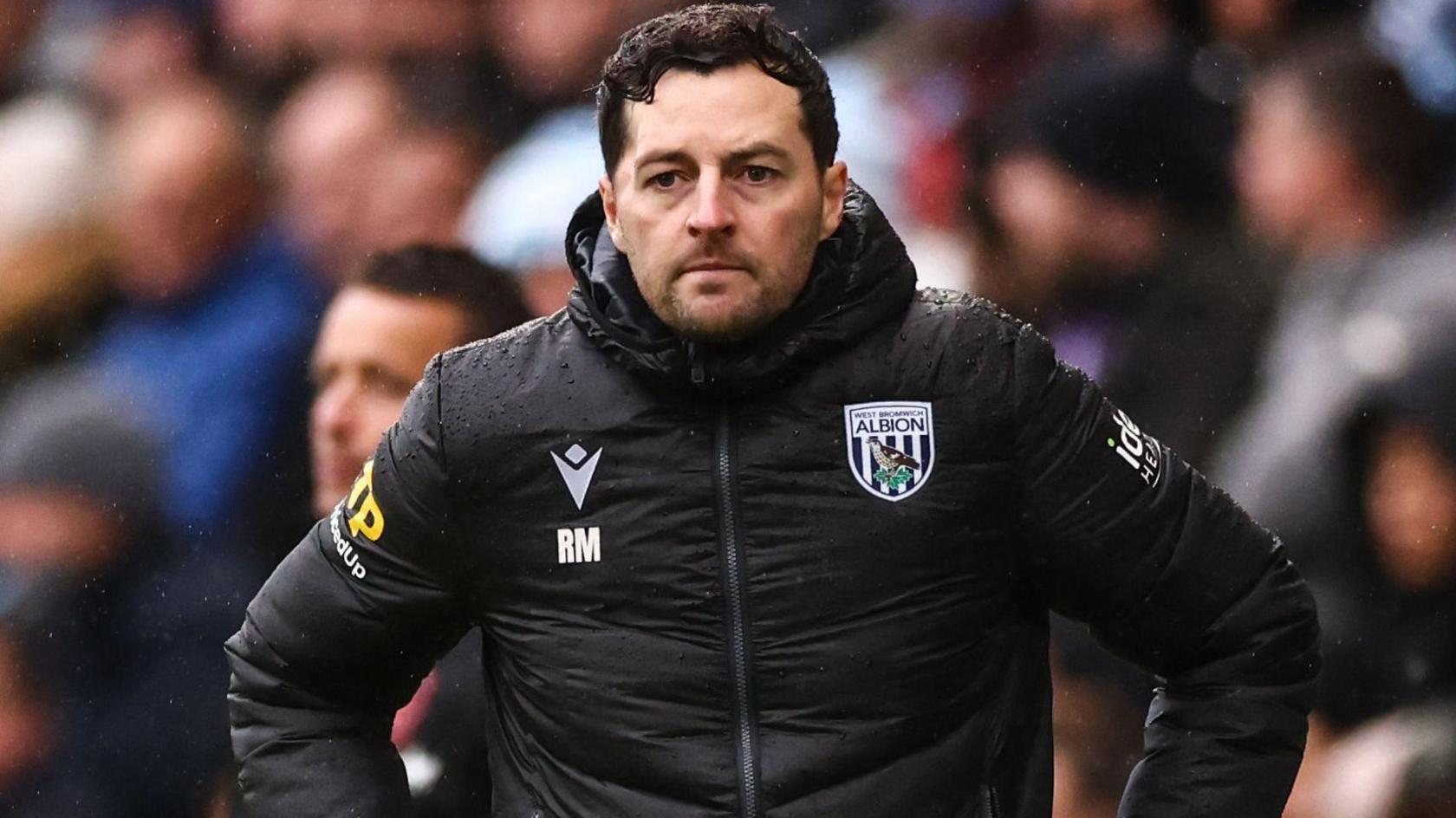 Ryan Mason standing with his hands on hips on the touchline at Coventry