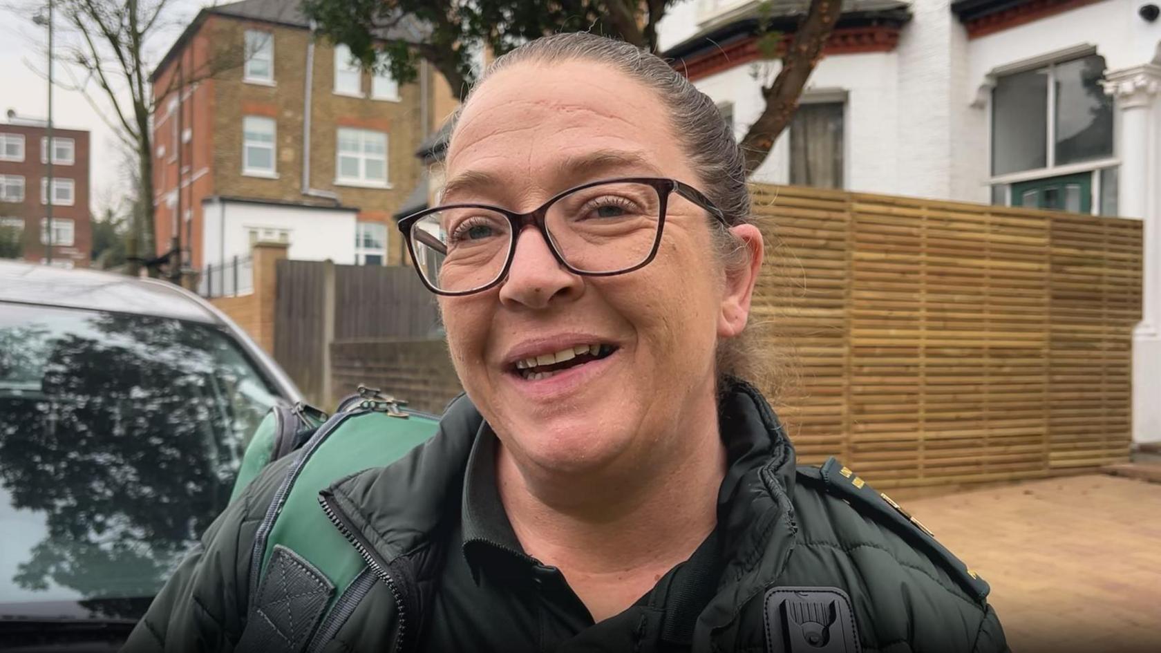 Paramedic Nicola Hughes in uniform on a London street.