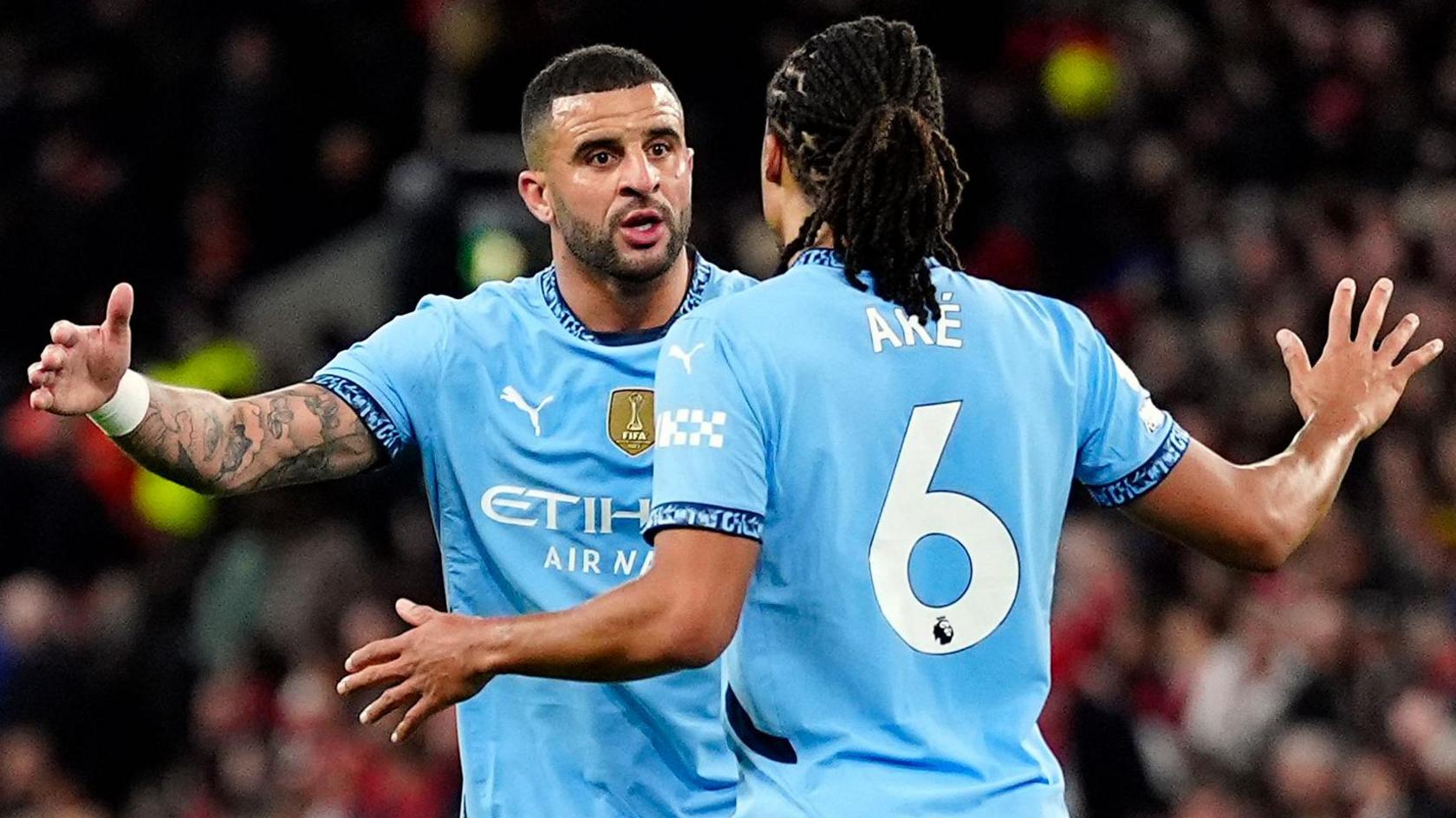 Kyle Walker high-fives team-mate Nathan Ake during Manchester City's defeat at Liverpool