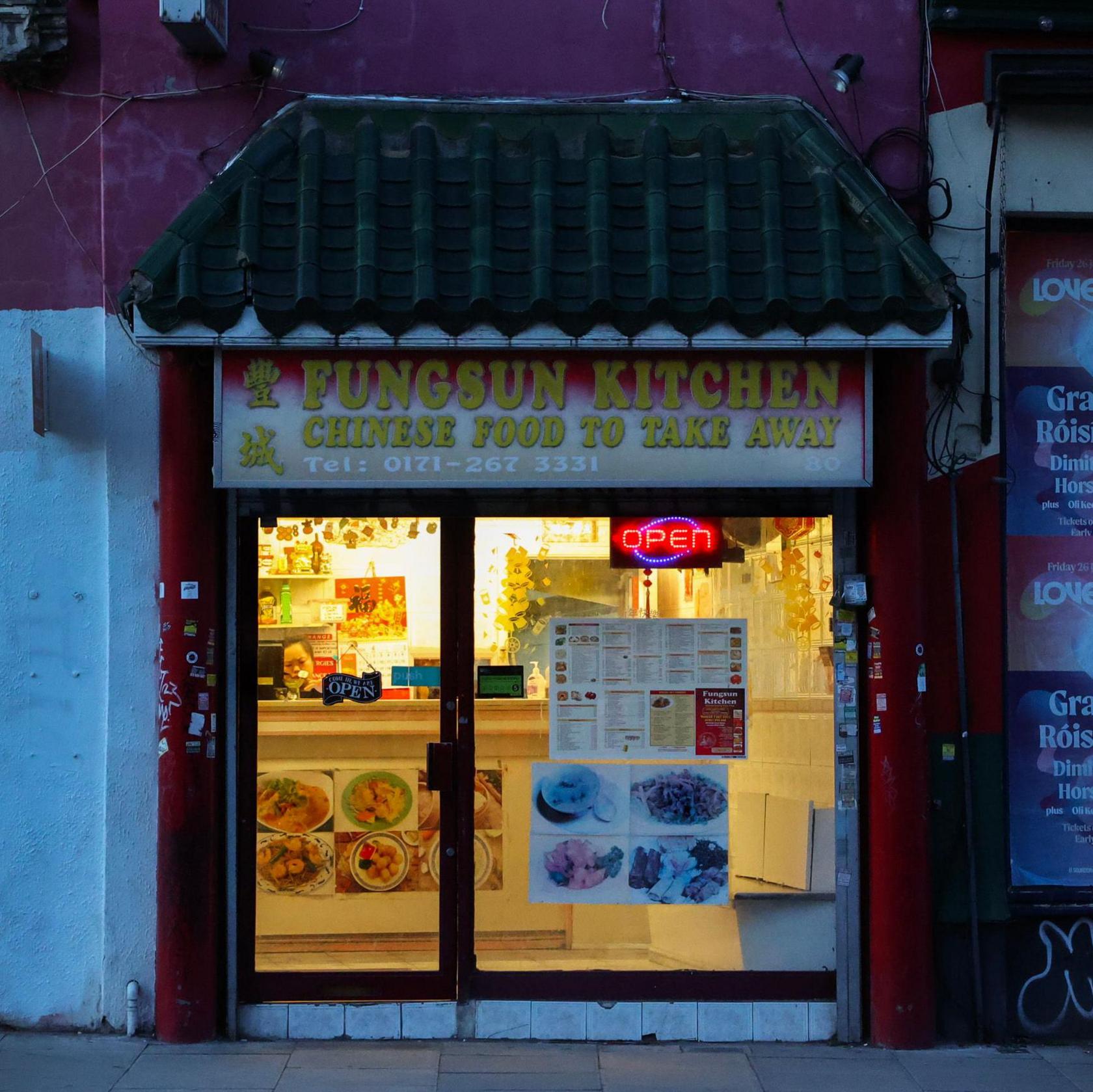 Woman behind counter in Chinese takeaway in Camden