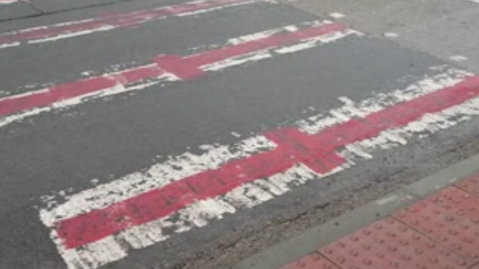 Zebra crossing in Ashford painted with red St George's Crosses on each white stripe