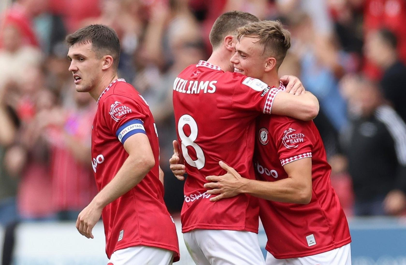 Bristol City players embrace, with goalscorer Scott Twine to the right, as they celebrating beating Milwall 4-3 at Ashton Gate