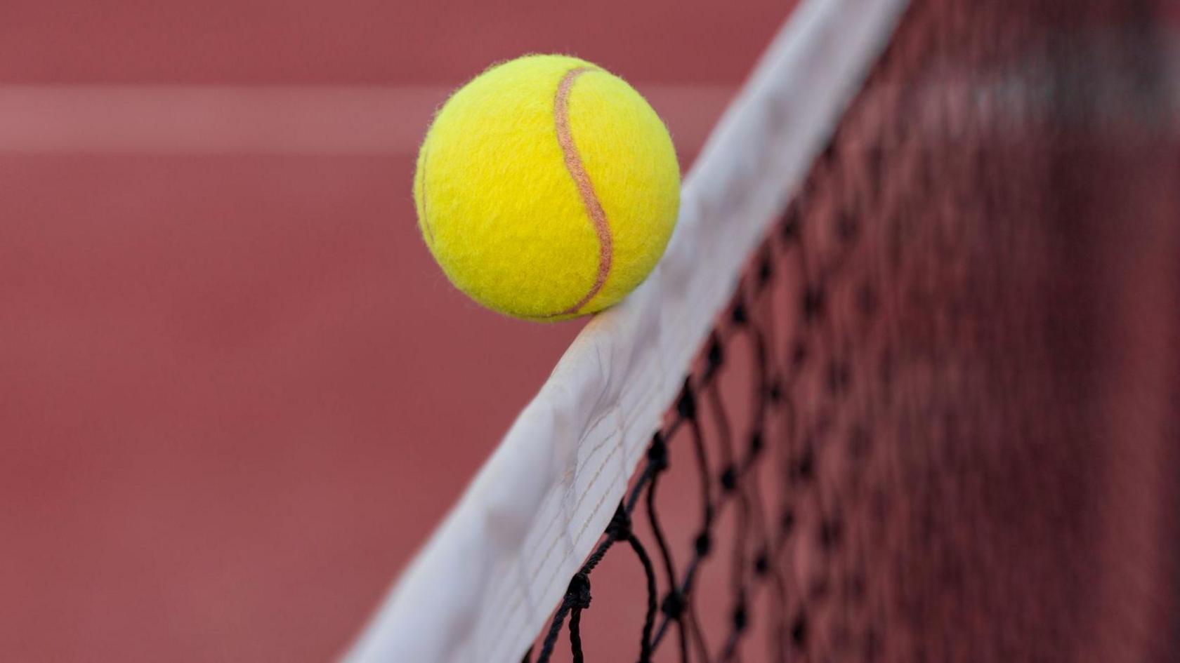 A tennis ball hitting the net 