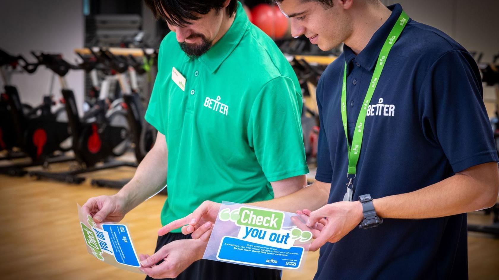 Staff at Better gym holding the new sticker