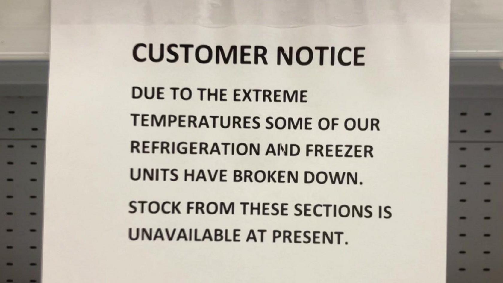 A notice in a store saying 'due to the extreme temperatures some of our refrigeration and freezer units have broken down. Stock from these sections is unavailable at present. We apologise for the inconvenience'.