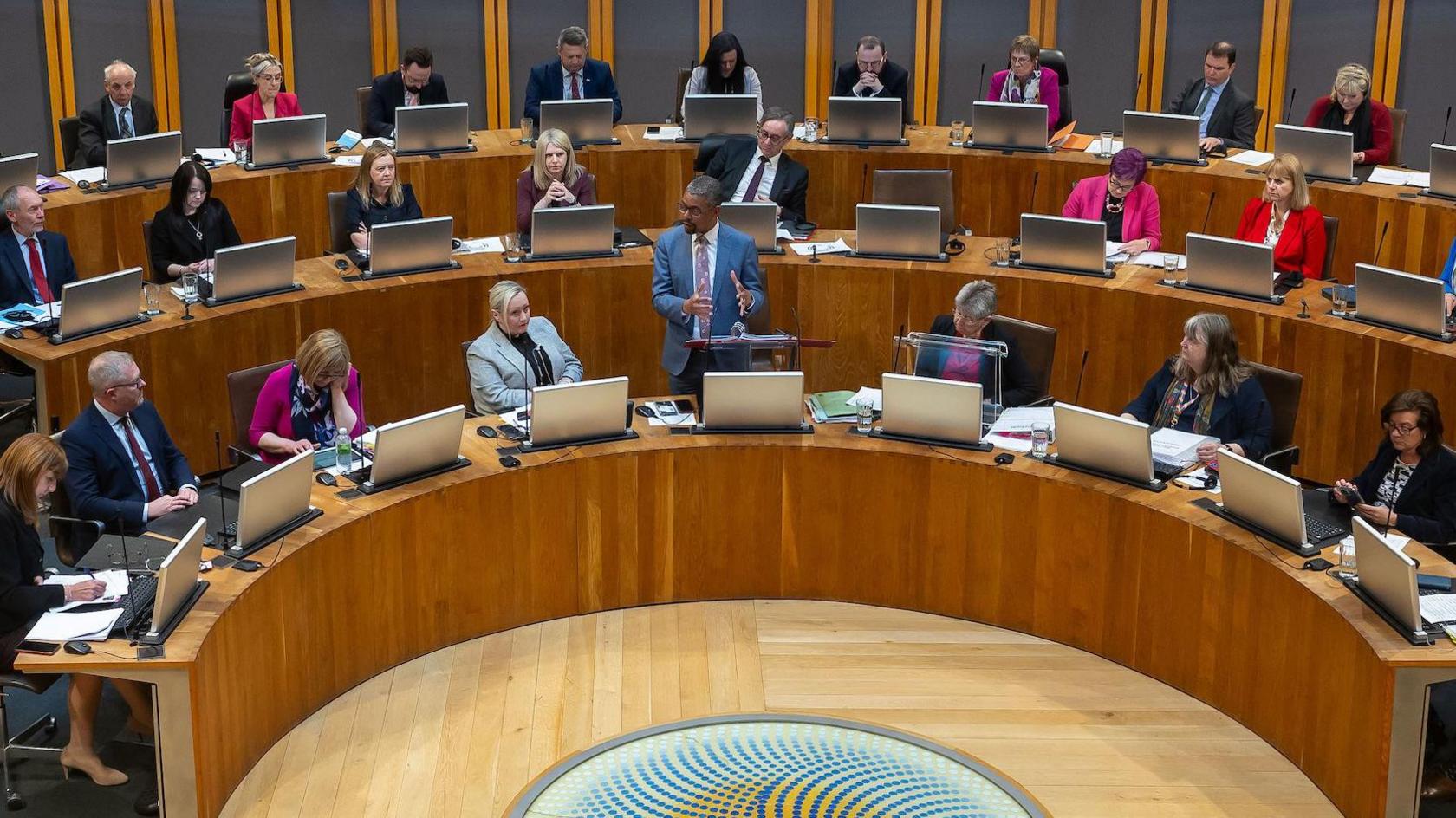 Vaughan Gething addressing the members of the Welsh Parliament in the Senedd