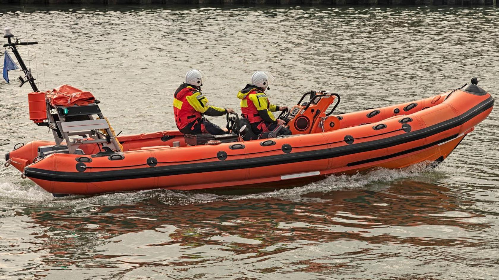 Close up of RNLI staff on a lifeboat in the sea