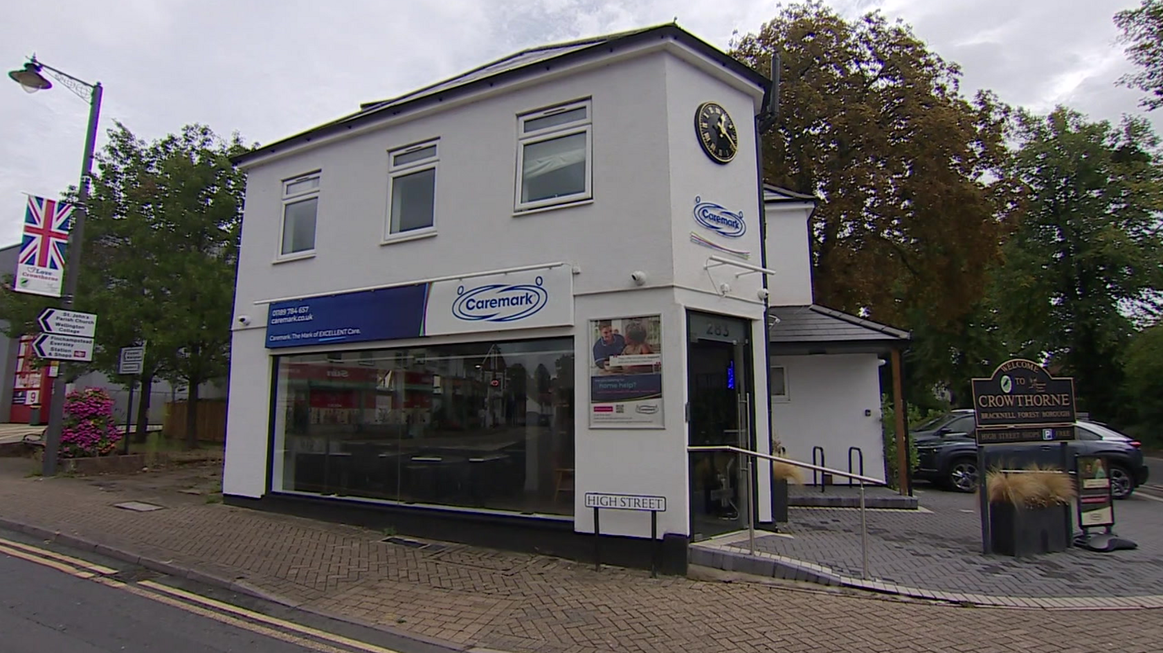 Caremark's HQ in Crowthorne, a white building with a sign for High Street outside.