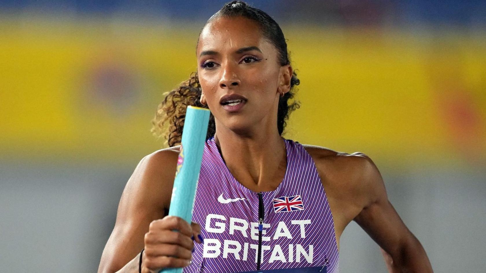 Lina Nielsen in a Great Britain kit, running with a baton