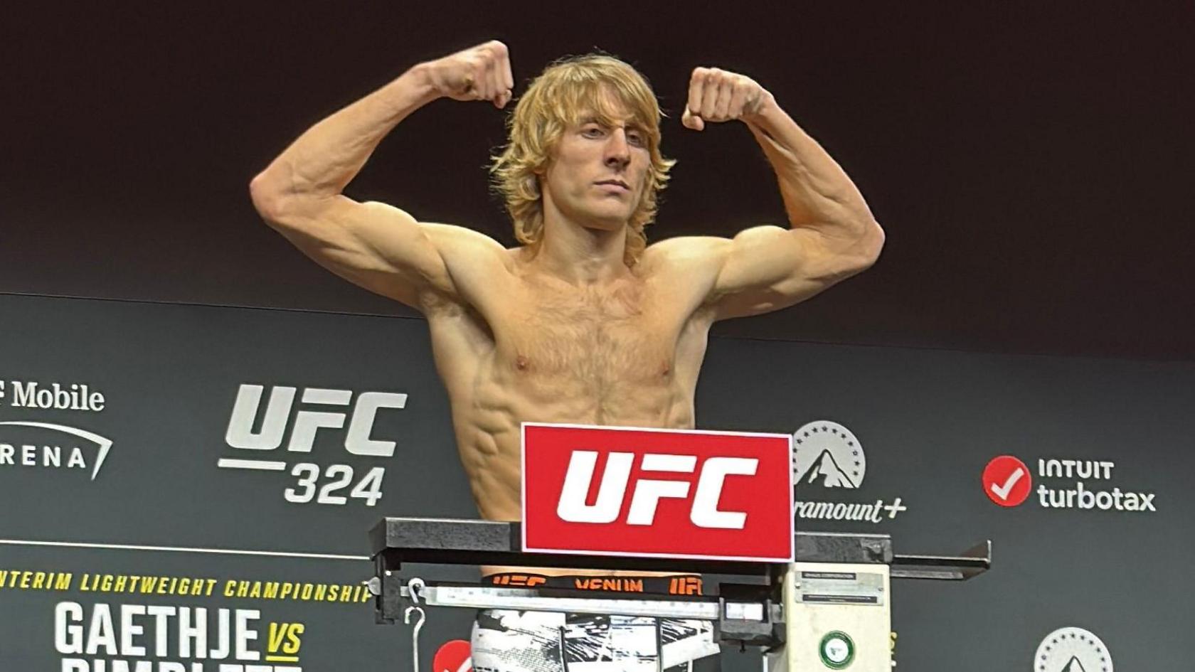 Paddy Pimblett flexes his muscles as he weighs in 
