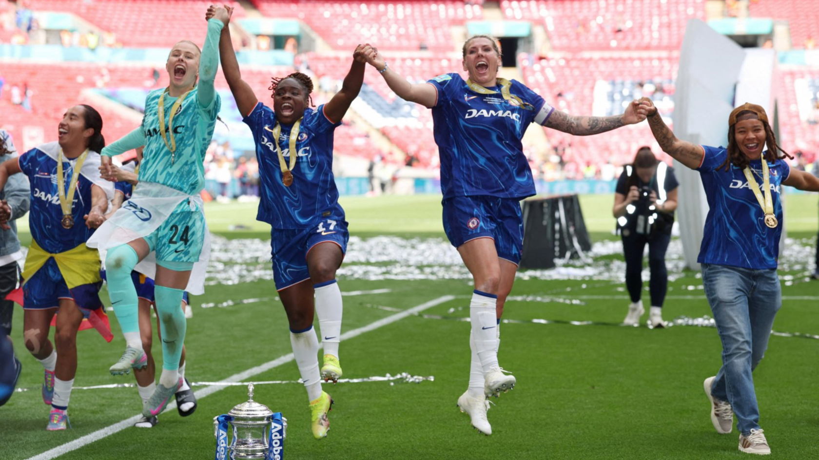 Chelsea's Hannah Hampton, Sandy Baltimore and Millie Bright celebrate with the trophy after winning the FA Cup