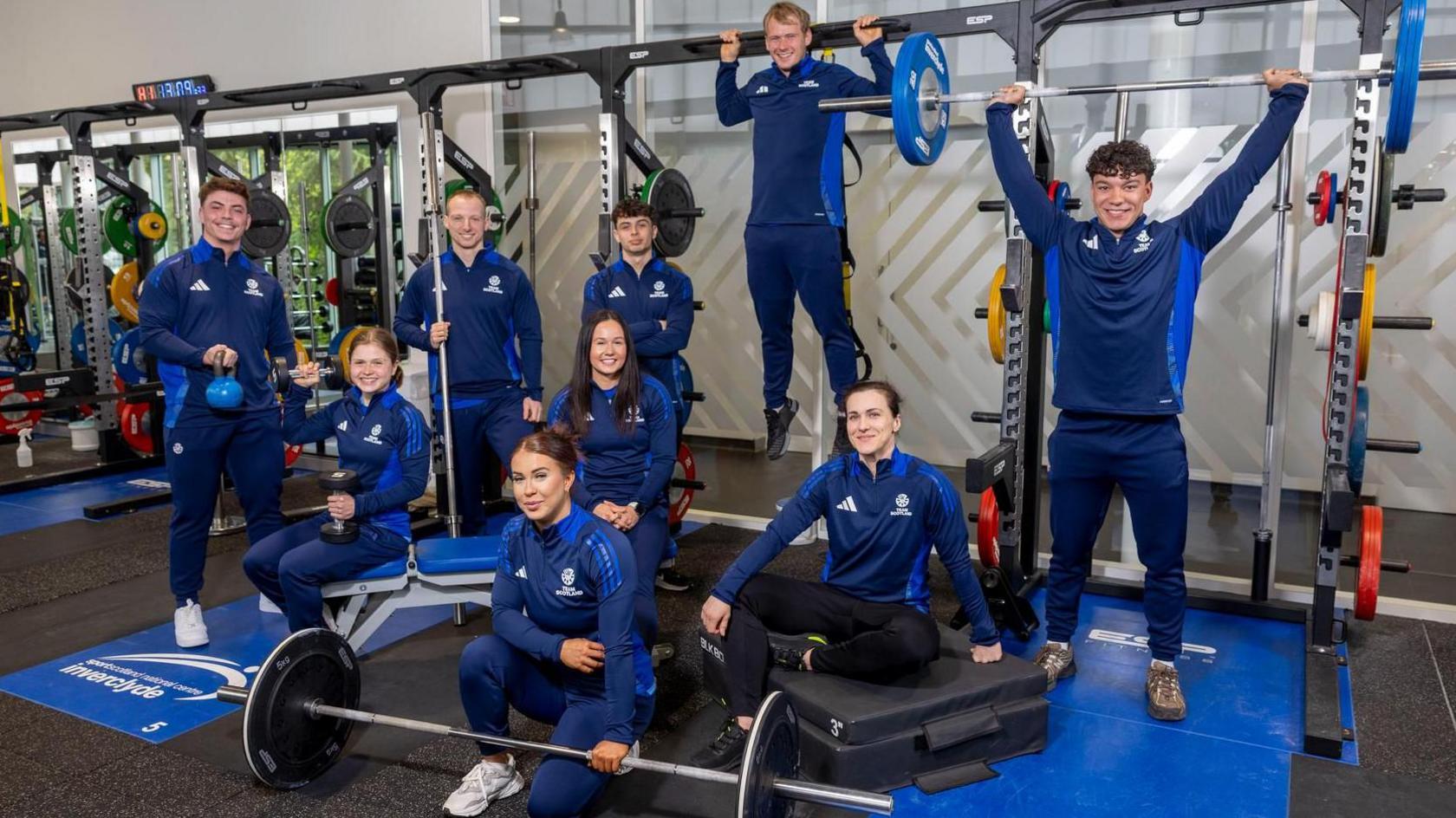 Scotland's weightlifting team for the Commonwealth Games strike various poses in the gym