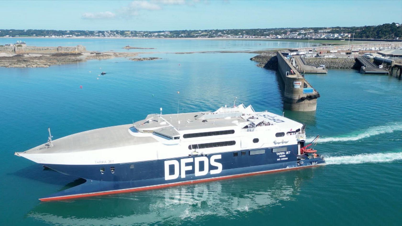 DFDS Tarifa Jet leaving the harbour on a clear day with blue skies, in St Helier, Jersey