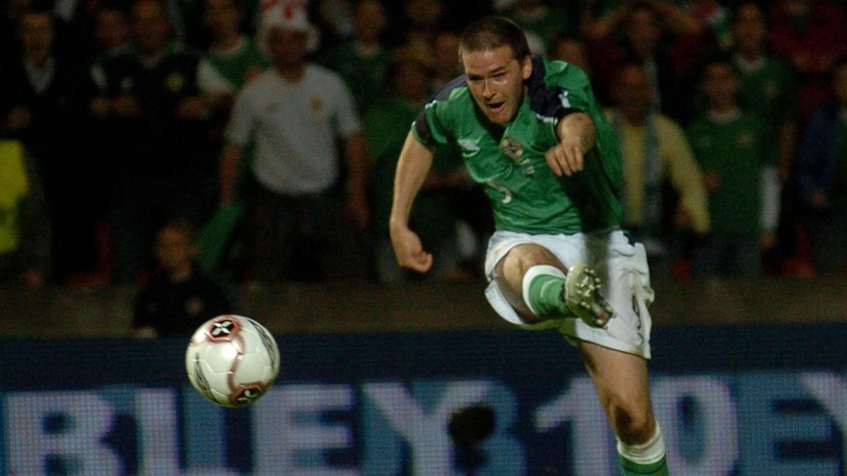 David Healy scores a goal against England