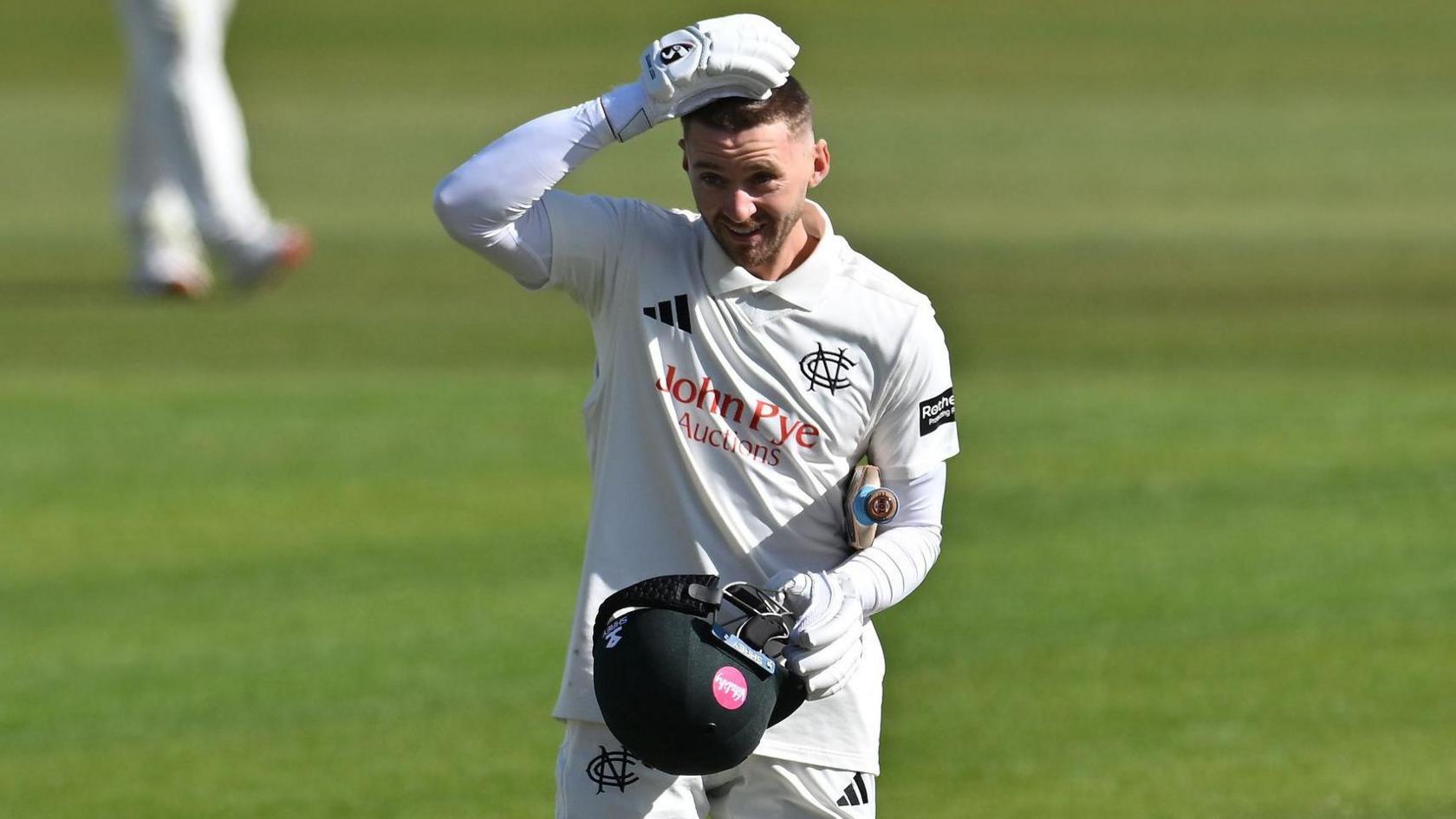 Joe Clarke celebrates with his helmet off for Nottinghamshire after scoring a century against Glamorgan