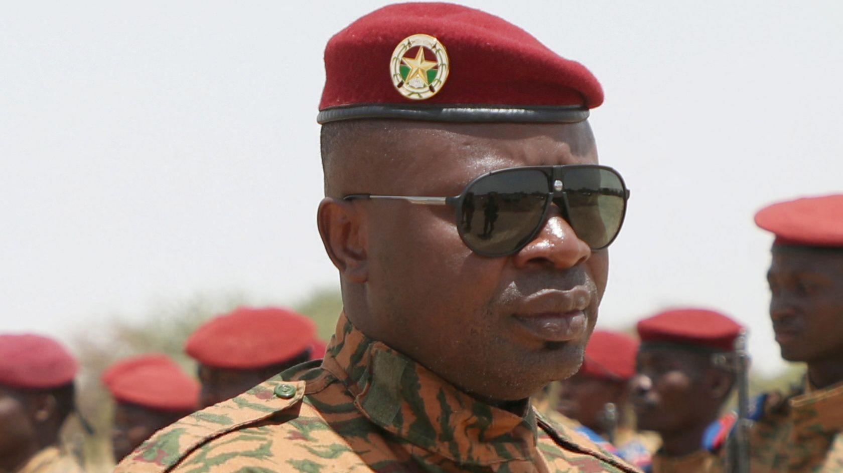 Paul-Henri Sandaogo Damiba in June 2022. A man in army fatigues, red beret and black sunglasses inspects soldiers who are standing to attention.